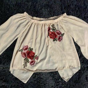 Medium sized cream off shoulder shirt with an open back